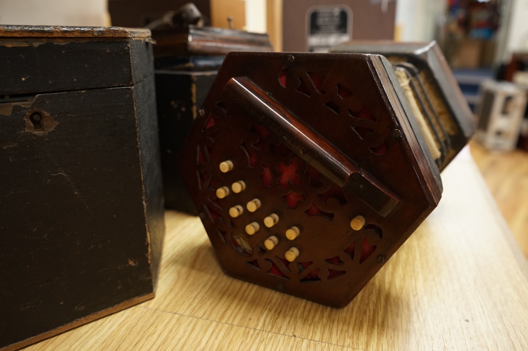 Two cased concertinas; one in mahogany with original paper label for Lachenal & Co., London, the other in rosewood (a.f.)